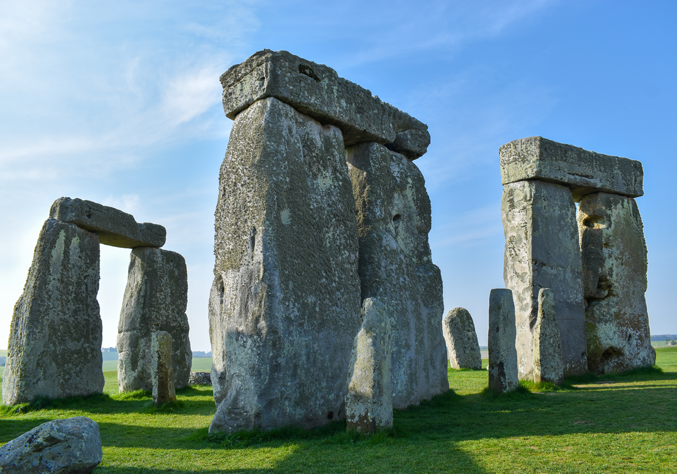 A view of the trilithon stones at Stonehenge. Three sets of two stones standing upright with a third on top forming a kind of arch